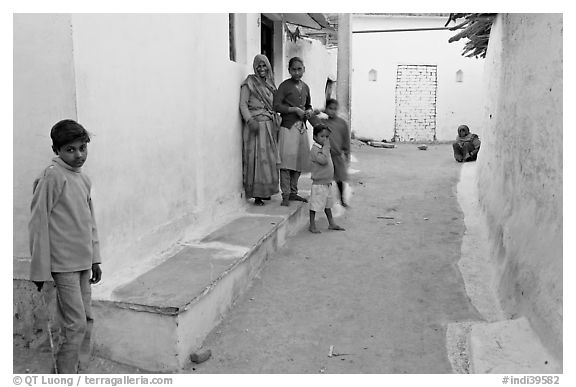Family in village alley. Khajuraho, Madhya Pradesh, India