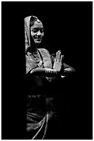 Woman joining hands in prayer gesture with dramatic lighting, Kandariya show. Khajuraho, Madhya Pradesh, India ( black and white)