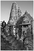 Worshipers going down stairs in front of Lakshmana temple. Khajuraho, Madhya Pradesh, India (black and white)