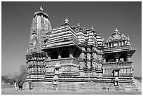 Devi Jagadamba temple with women walking. Khajuraho, Madhya Pradesh, India (black and white)