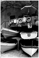Tiny fishing boats stacked in the main square, Riomaggiore. Cinque Terre, Liguria, Italy (black and white)