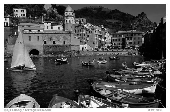 Colorful fishing boats in the harbor and Piazza Guglielmo Marconi, Vernazza. Cinque Terre, Liguria, Italy