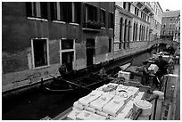 Delivery through a little canal. Venice, Veneto, Italy ( black and white)