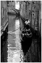 Gondola and reflections in a narrow canal. Venice, Veneto, Italy (black and white)