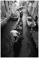 Gondolas lined up in narrow canal. Venice, Veneto, Italy (black and white)