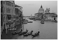 Gondolas, Grand Canal, Santa Maria della Salute church from the Academy Bridge,  sunset. Venice, Veneto, Italy (black and white)