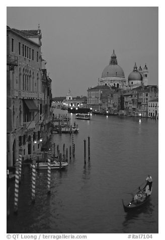 Gondola, Grand Canal, Santa Maria della Salute church from the Academy Bridge, dusk. Venice, Veneto, Italy (black and white)