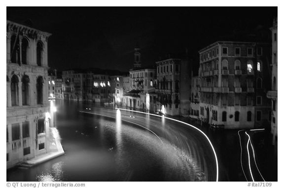 Light trails on the Grand Canal at night near the Rialto Bridge. Venice, Veneto, Italy (black and white)