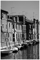 Canal lined with brightly painted houses, Burano. Venice, Veneto, Italy (black and white)