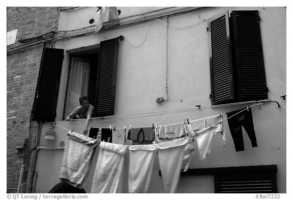 Woman hanging laundry. Siena, Tuscany, Italy (black and white)