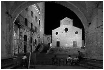 Duomo framed by an arch at night. San Gimignano, Tuscany, Italy (black and white)