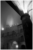 Medieval towers above Piazza del Duomo, foggy night. San Gimignano, Tuscany, Italy ( black and white)
