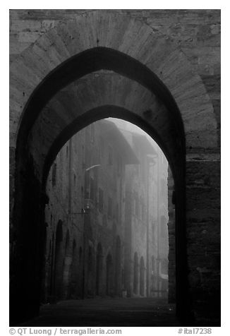 Arch at dawn in the fog. San Gimignano, Tuscany, Italy
