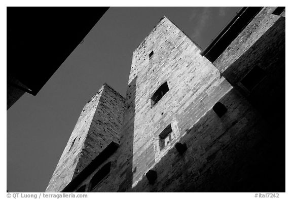 Medieval tower seen from the street, early morning. San Gimignano, Tuscany, Italy