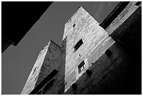 Medieval tower seen from the street, early morning. San Gimignano, Tuscany, Italy (black and white)