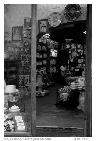 Woman painting plates in a ceramic store. Orvieto, Umbria (black and white)