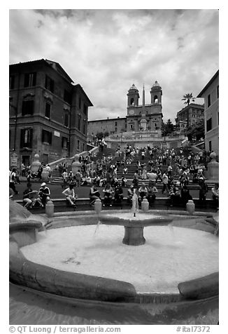Fontana della Barcaccia and Spanish Steps covered with tourists sitting. Rome, Lazio, Italy