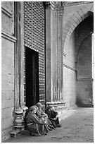 Nuns sit outside of one of  many churches of the historic town. Naples, Campania, Italy (black and white)