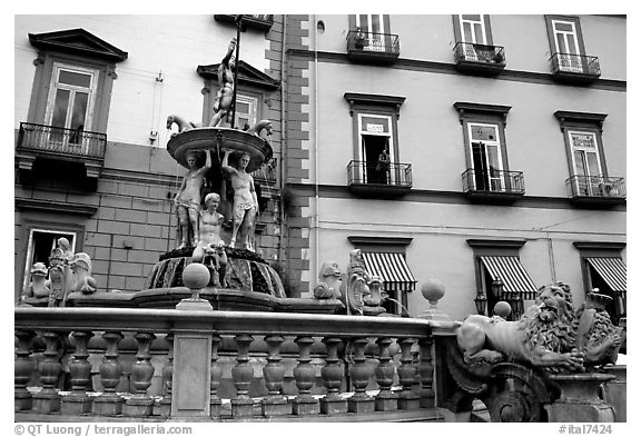 Fountain with man at balcony in background. Naples, Campania, Italy (black and white)