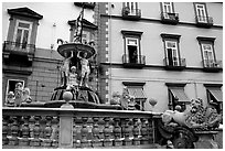 Fountain with man at balcony in background. Naples, Campania, Italy ( black and white)