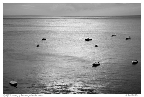 Small boats at sunset in the Gulf of Salerno, Positano. Amalfi Coast, Campania, Italy (black and white)