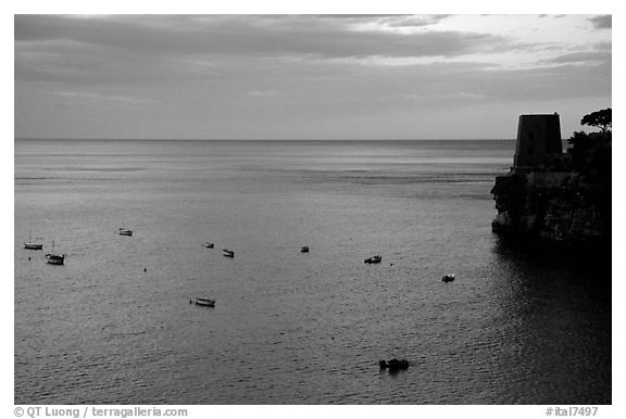 Small boats and tower and sunset, Positano. Amalfi Coast, Campania, Italy