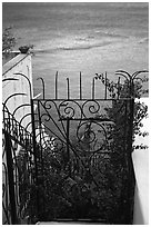 Forged metal entrance to a garden overlooking the sea, Positano. Amalfi Coast, Campania, Italy (black and white)