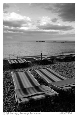 Beach chairs on Spiaggia del Fornillo at sunset, Positano. Amalfi Coast, Campania, Italy (black and white)