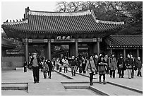 People walking down gate, Changdeok Palace. Seoul, South Korea ( black and white)