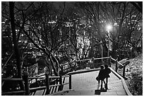 Couple walking down Namsan stairs by night. Seoul, South Korea ( black and white)
