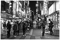 Shoppers on pedestrian street by night. Seoul, South Korea (black and white)