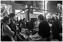 Busy food stall by night. Seoul, South Korea ( black and white)