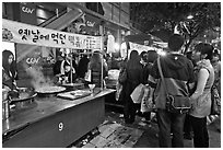 People lining up for street food. Seoul, South Korea ( black and white)
