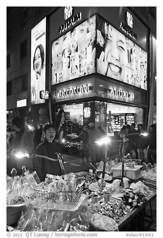 Street food vendor and cosmetics store by night. Seoul, South Korea