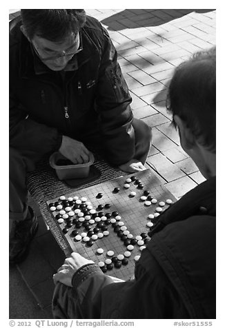 Pondering moves in go (baduk) game. Seoul, South Korea (black and white)