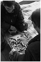 Pondering moves in go (baduk) game. Seoul, South Korea (black and white)