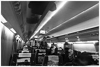 Hostess walking inside high speed KTX train car. Seoul, South Korea (black and white)