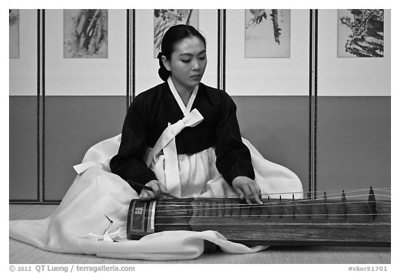 Woman playing traditional instrument. South Korea