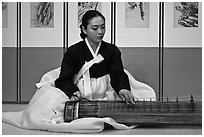 Woman playing traditional instrument. South Korea (black and white)