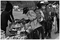 Hikers check out stand selling natural products. South Korea ( black and white)
