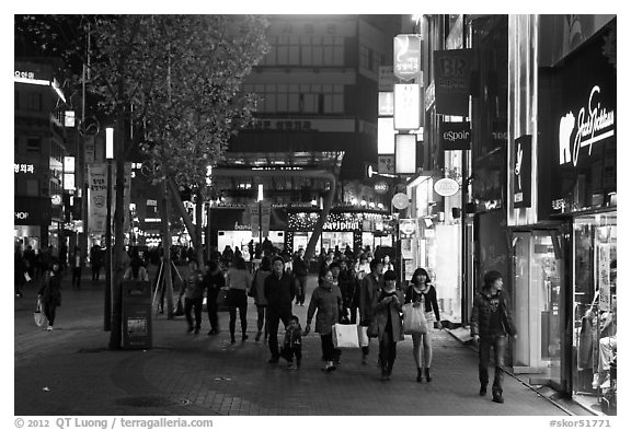 Shoppers strolling on pedestrian street at night. Daegu, South Korea