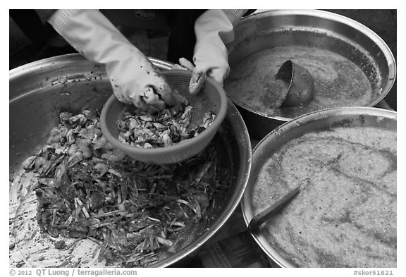 Hands mixing kim chee. Gyeongju, South Korea (black and white)
