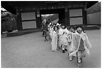 Schoolchildren with raingear, Bulguksa. Gyeongju, South Korea ( black and white)