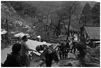 Hikers receiving sacred bread at Sangseonam hermitage, Mt Namsan. Gyeongju, South Korea ( black and white)