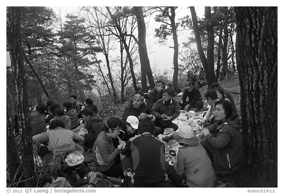 Large group of hikers eating on Geumobong Peak, Namsan Mountain. Gyeongju, South Korea (black and white)