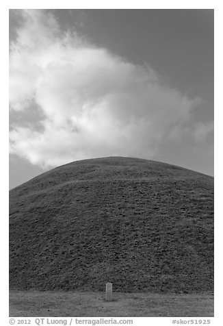 Mound of earth raised over grave and cloud. Gyeongju, South Korea