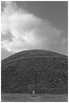 Mound of earth raised over grave and cloud. Gyeongju, South Korea ( black and white)