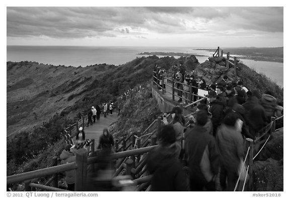 Tourists on top of Seongsang Ilchulbong. Jeju Island, South Korea (black and white)