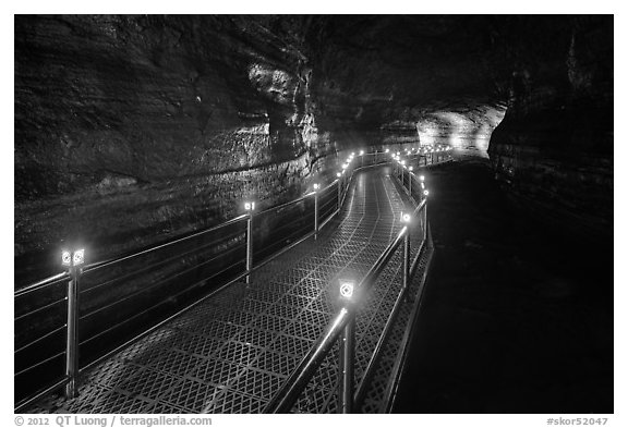 Walkway in Geomunoreum cave with world heritage logos. Jeju Island, South Korea (black and white)