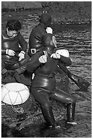 Haeneyo women arranging wetsuits. Jeju Island, South Korea (black and white)